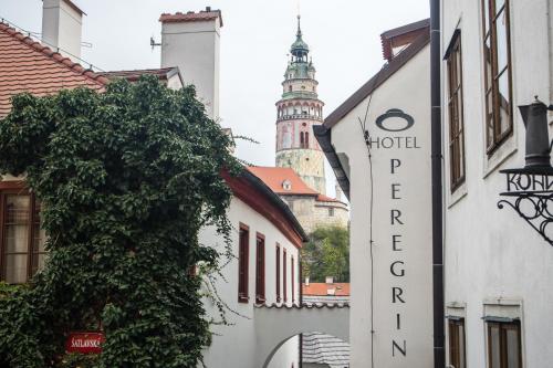 a building with a hotel sign and a tower at Hotel Peregrin in Český Krumlov