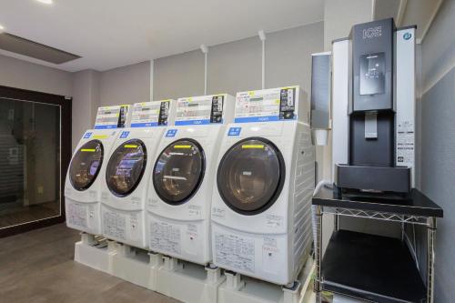 a row of washing machines on display in a store at HOTEL MYSTAYS Kanazawa Katamachi in Kanazawa