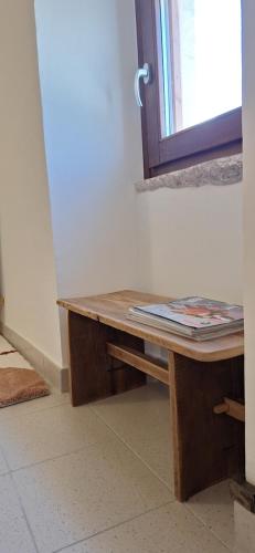 a wooden table in a room with a mirror at Apartment C-MM09 in Bussi sul Tirino