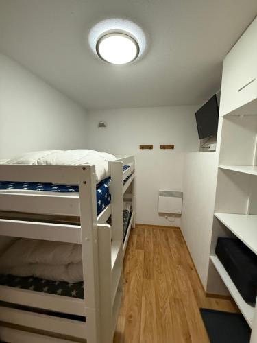 une chambre avec un lit superposé dans une pièce dans l'établissement La Foux d Allos Les Cimes, à Allos