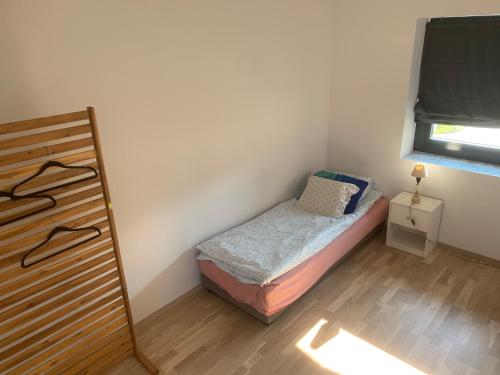 a small bedroom with a small bed and a window at Peer Gynts vei 77 in Moss