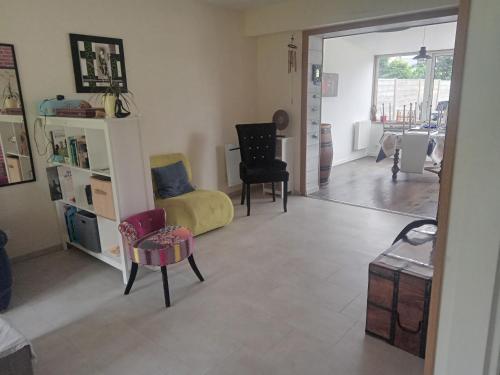 d'un salon avec un canapé et des fauteuils jaunes. dans l'établissement la tiny aux portes de brest, à Guilers