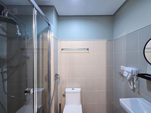a bathroom with a shower and a toilet and a sink at 1BR Condotel with Balcony at FAME Residences #FM58-1 in Manila