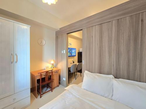 a bedroom with a bed and a desk and a deskablish at 1BR Condotel with Balcony at FAME Residences #FM58-1 in Manila