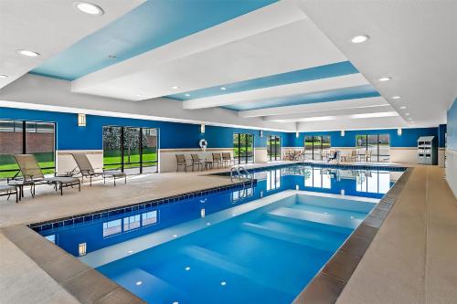 a pool in a hotel room with blue walls at Hampton Inn Omaha/West Dodge Road, Old Mill in Omaha