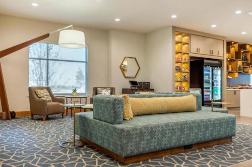 a living room with a couch and a chair at Cambria Hotel Davenport Quad Cities in Bettendorf