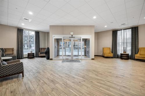 an empty lobby with chairs and tables and glass doors at Hampton Inn And Suites Logan, Ut in Logan