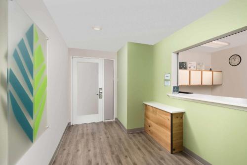 a room with green and white walls and a desk at WoodSpring Suites Spartanburg - Duncan in Duncan