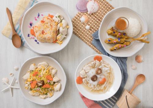 a table with three plates of food on it at Pimalai Resort & Spa in Ko Lanta