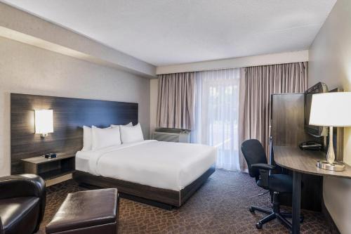 a hotel room with a bed and a desk at Quality Inn & Conference Centre Kingston Central in Kingston