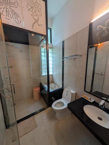 a bathroom with a toilet and a sink and a shower at Tathastu Pench in Khawāsa