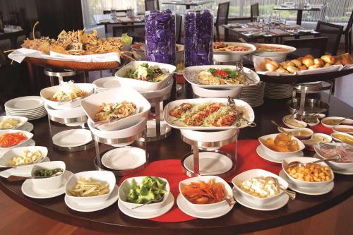 a table with many different dishes of food on it at Radisson Hotel Decapolis Miraflores in Lima