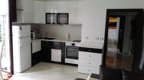 a white kitchen with black and white appliances at Black & White in Burgas