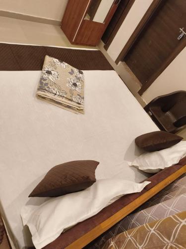 a bed with two pillows on top of it at Shri Radha Kunj Vrindavan in Vrindāvan