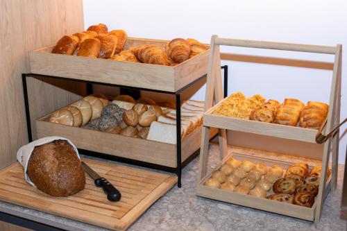 a display of different types of bread and pastries at Jill Hotel Brussels in Brussels