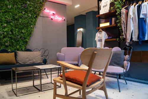 a store with chairs and a table and a mirror at Terrass" Hotel in Paris