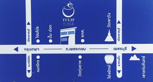 a blue and white sign with arrows on it at Tulip Place in Ratchaburi