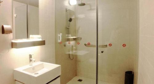 a bathroom with a shower and a sink and a shower at Jinjiang Inn Select Beijing Miyun Development Zone in Miyun