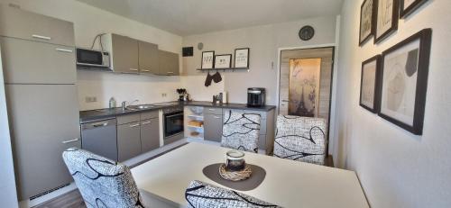 a kitchen with a table and chairs in a kitchen at Katrins Ferienwohnung in Hammelburg