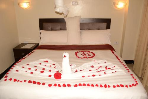 a bed with a bride and groom made out of roses at Lakemark Hotel and Tour Service Bahir Dar in Bahir Dar