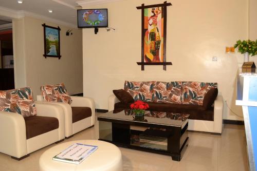 a living room with two couches and a coffee table at Lakemark Hotel and Tour Service Bahir Dar in Bahir Dar