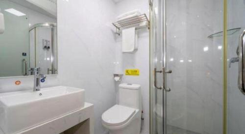 a bathroom with a toilet and a sink and a shower at 7 Days Inn Guilin Beiji Plaza Yushan Garden in Guilin