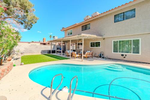 a swimming pool in front of a house at Spacious Lux Estate l 8 mins to Strip in Las Vegas