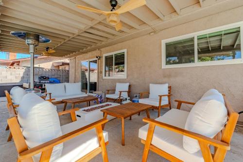 a patio with tables and chairs and a ceiling at Spacious Lux Estate l 8 mins to Strip in Las Vegas