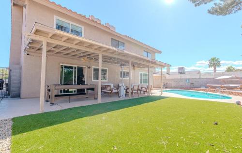 a house with a patio and a pool at Spacious Lux Estate l 8 mins to Strip in Las Vegas