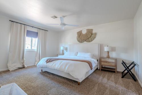 a white bedroom with a bed and a window at Spacious Lux Estate l 8 mins to Strip in Las Vegas