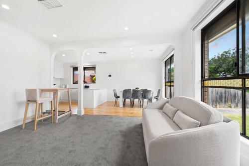 a living room with a couch and a table at Home Away From Home in Braybrook