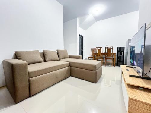 a living room with a couch and a table at Grand Kalasan Homestay Jogja in Tanjungtirto