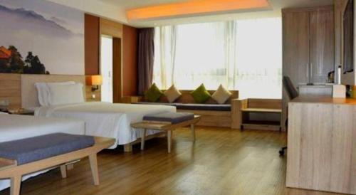 a hotel room with two beds and a couch at Atour Hotel Xi'an High Tech Dazhai Road in Xi'an