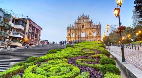 ancient building with a hedge in front of a building at London Hotel in Macau