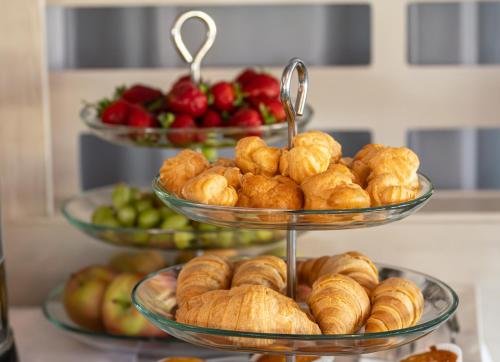a display of three tiered plates of pastries and fruit at Villa Four Rooms in Kharkiv