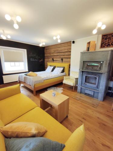 a living room with two beds and a fireplace at Arte Golf Apartment in Kuressaare