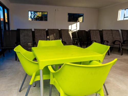a yellow table and chairs in a room at The Space Guesthouse in Vryheid