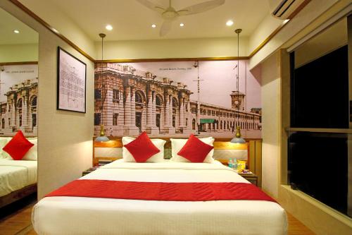 a hotel room with a large bed with red pillows at Theory9 Premium Service Apartments Khar in Mumbai
