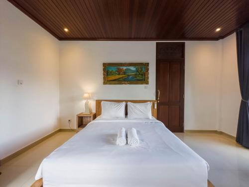 Ένα ή περισσότερα κρεβάτια σε δωμάτιο στο Tiara Guest House Ubud