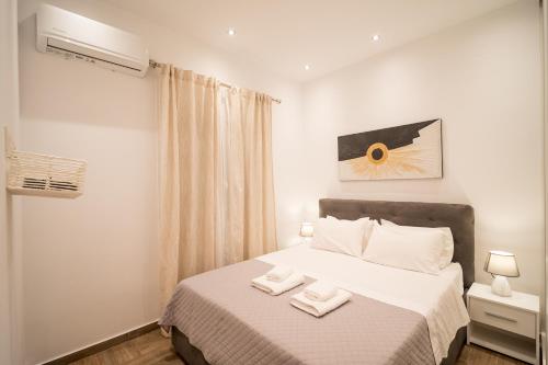 a bedroom with a bed with two towels on it at Kyra's Luxury Suites 2 in Chios