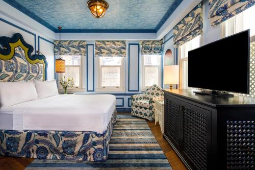 a bedroom with a bed and a flat screen tv at Hagia Sofia Mansions Istanbul, Curio Collection by Hilton in Istanbul