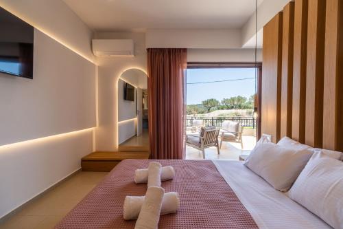 a bedroom with a bed with two towels on it at Villa Aetheria by PosarelliVillas in Plátanos