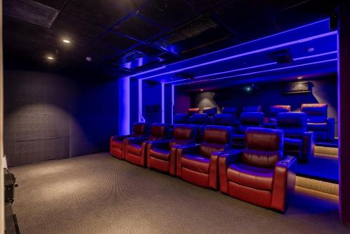 a theater room with red chairs and blue lights at Quality Inn Patria Suites, Rajkot in Rajkot