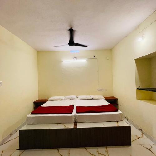 a bedroom with a bed and a ceiling fan at Kaustubha beach villa in Udupi
