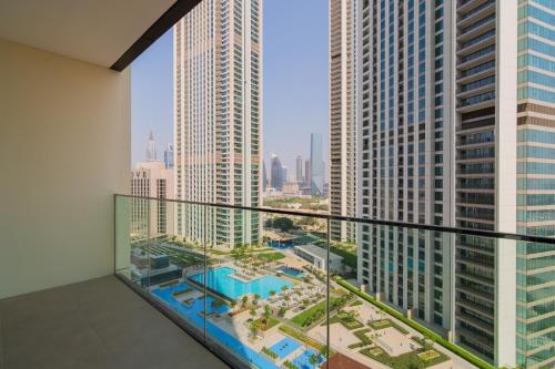 a balcony with a view of a city with tall buildings at Elite Escape Holiday Home - 1 BHK Getaway with Dubai Mall Access - 1502 in Dubai