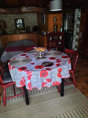 a table with a red and white table cloth at Chambre de caractere in Celles