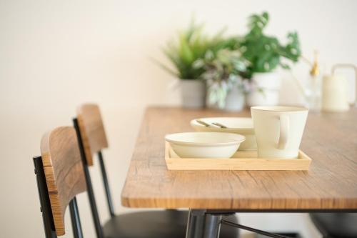 a wooden table with two bowls on a tray at Residence Hotel KABUTO in Sapporo
