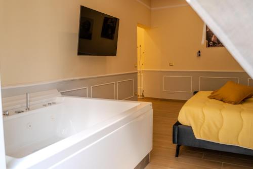 a room with a bed and a bath tub at Luxury Acclavio Apartments in Taranto