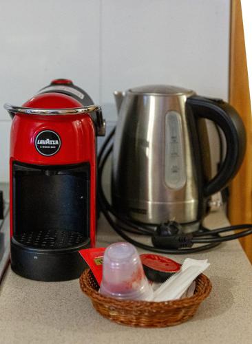 a red toaster and a basket on a counter at C'era una volta una Panetteria in Demonte