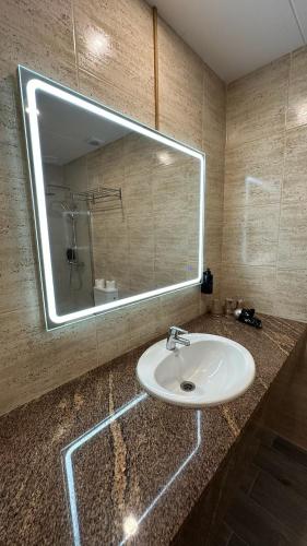 a bathroom with a sink and a large mirror at Hotel Sant March in Tossa de Mar